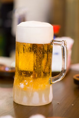 Mug of beer on wooden table