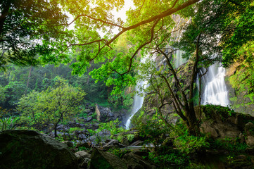 Obraz premium A beautiful waterfall deep in the tropical forest, steep mountain adventure in the rainforest.