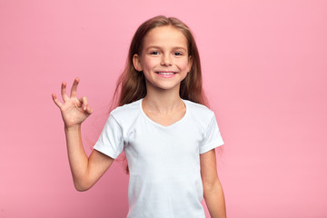 cheerful beautiful blonde girl showing okay sign, close up portrait, body languge, agreement,...