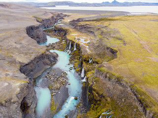 Scenic landscape view of incredible Sigoldugljufur canyon in highlands with turquoise river, Iceland. Volcanic landscape on background. Popular tourist attraction..