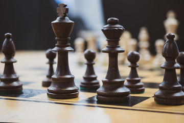 wooden chess pieces on the table closeup