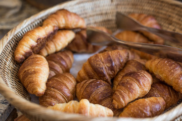 delicious fresh croissants in basket.
