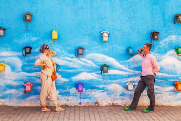 Guy and a girl are talking on an old fashioned phone. Communication concept.