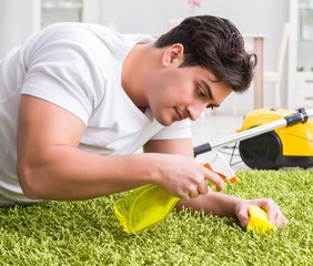 Young husband man cleaning floor at home