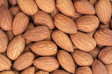 Close up raw peeled almonds seed abstract background and texture.