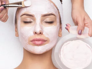 Door stickers Beauty salon woman receiving  facial mask in spa beauty salon