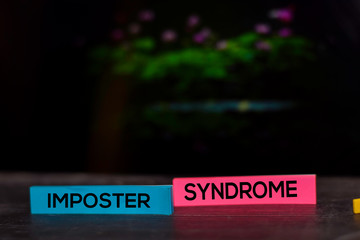 Imposter Syndrome text on sticky notes isolated on bokeh background