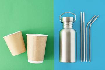 Zero waste eco friendly concept. Reusable plastic free items on a colorful blue and green background. Top view of aluminun bottle, metal tubes and paper coffee cups