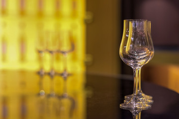 Empty wine glass on table in pub or restaurant background with copyspace