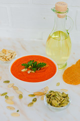 Appetizing orange pumpkin cream soup. Lunch for Halloween.