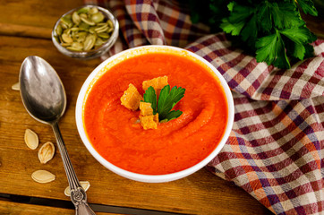 Appetizing orange pumpkin cream soup. Lunch for Halloween.