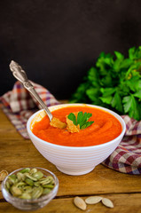 Appetizing orange pumpkin cream soup. Lunch for Halloween.