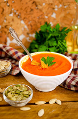 Appetizing orange pumpkin cream soup. Lunch for Halloween.