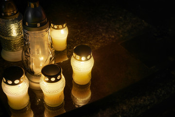 Burning candles at a cemetery before All Saints Day (1st November).