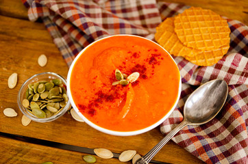 Appetizing orange pumpkin cream soup. Lunch for Halloween.
