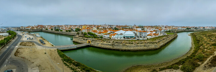 Fototapeta na wymiar Aerial panoramic view of fishing village of Peniche on the Portuguese coast with former prison fortress
