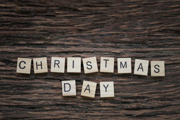 Fototapeta premium Christmas letters on a wooden floor and a copy space.