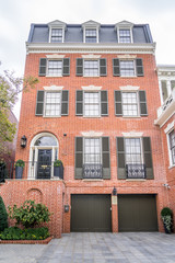 Fototapeta na wymiar Georgian colonial style multi story luxury house with dormer windows and red brick facade in Georgetown Washington DC USA