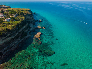Aerial view of the Calabrian coast, cliffs overlooking the crystal clear sea and luxury villas. Locality of Riaci south of Tropea. Calabria. Italy