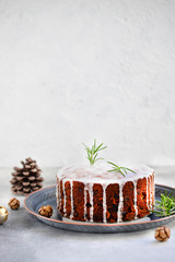 Traditional Christmas cake with fruits and nuts on a light table and light background. Dessert for...