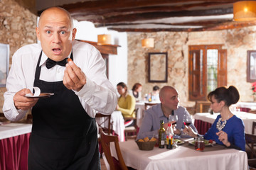 Fototapeta na wymiar Waiter upset with little tips