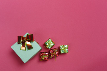 Christmas gift boxes and decorations on red art paper background.