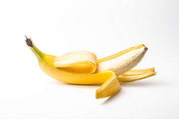 ripe yellow banana half peeled on a white background isolate