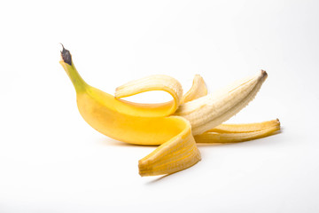 ripe yellow banana half peeled on a white background isolate