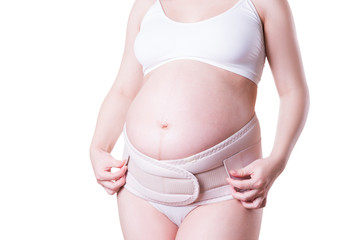 Pregnant woman with orthopedic support belt, isolated on white background