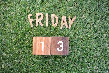 Friday 13th on green grass. bad luck, Misfortune Day, Halloween Concept.