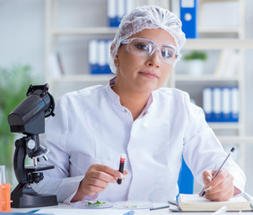 Female scientist researcher conducting an experiment in a labora