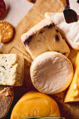 different kinds of cheese, charcuterie assortment, crackers, grapes, nuts and berries