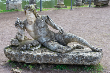 Fototapeta na wymiar Statue of Tiber at the side of pool named Canopus in Hadrian's Villa (Villa Adriana) in Tivoli, Italy.