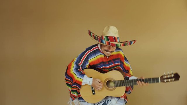 Young Mexican In National Costume Playing Guitar.