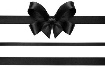 Black ribbon with gift bow isolated on white. Christmas festive bow of black shiny satin ribbon and horizontal lines of ribbon