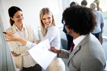 Group of business people discussing, brainstorming in office. Concentrated at work.