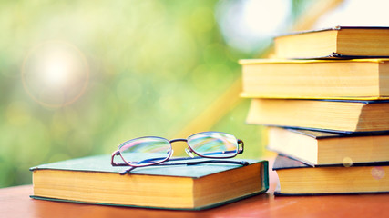 glasses and open book. best books home library background. read vintage books in a row. college library table. publishing