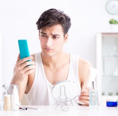 Young handsome man staring in the mirror