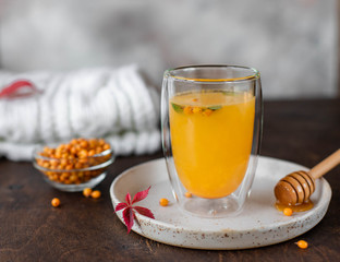 Sea buckthorn hot tea with mint and honey. herbal vitamin tea. wooden background, close-up