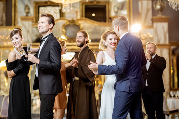 Group of elegant people dancing indoors