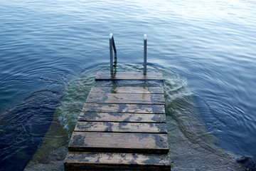Evening quiet sea and handrails for the descent into the sea.