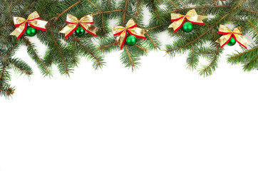 Branches of spruce decorated with balls with bows on a white background. Christmas background. Copy space.