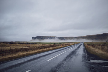 Perspective road with foggy mountain range background autumn season Iceland