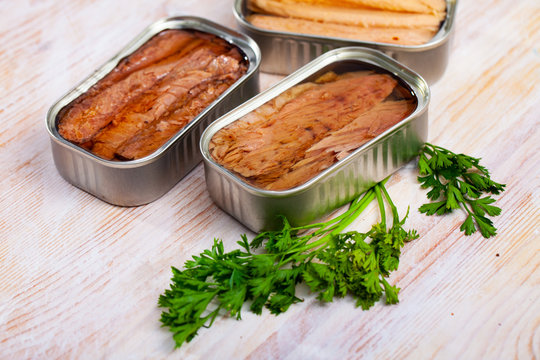 Natural Frigate Mackerel Fillets And Parsley Can On Wooden Table