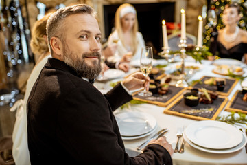 Man with friends during a festive dinner on New Years Eve
