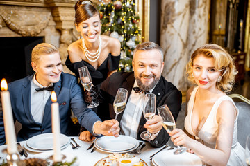 Portrait of an elegantly dressed people celebrating New Year holiday indoors