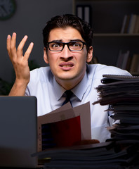 Young businessman working overtime late in office