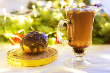 Hot drink with marshmallows on the background of Christmas decorations