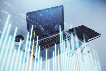 Forex graph hologram with desktop office computer background. Double exposure. Concept of financial...