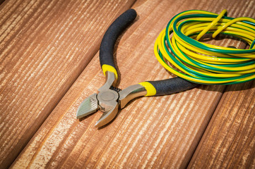Tool and spare parts for electrician on vintage wooden boards